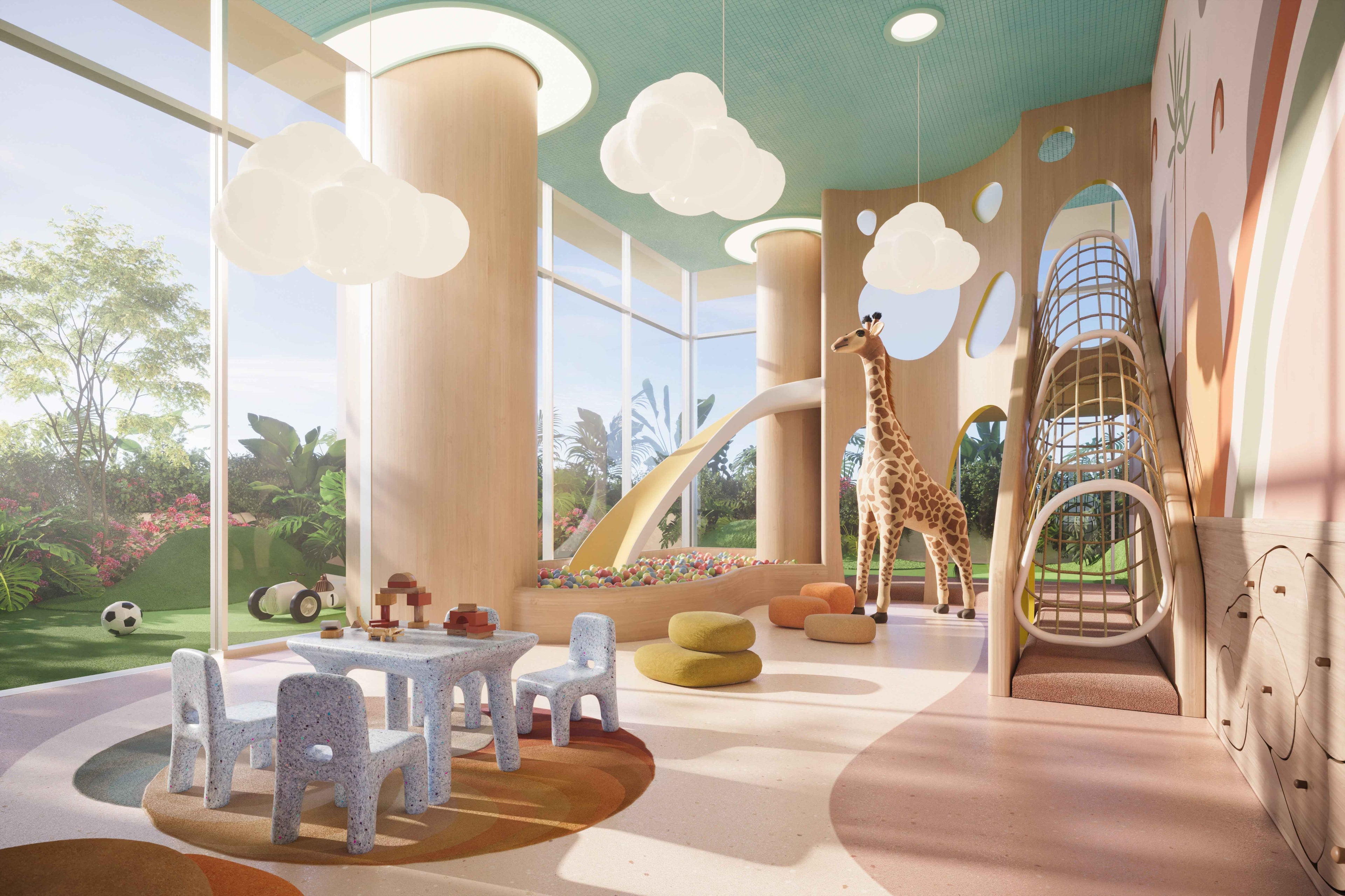 The Residences at Shell Bay Children's playroom with a giraffe statue, slide, and large windows.