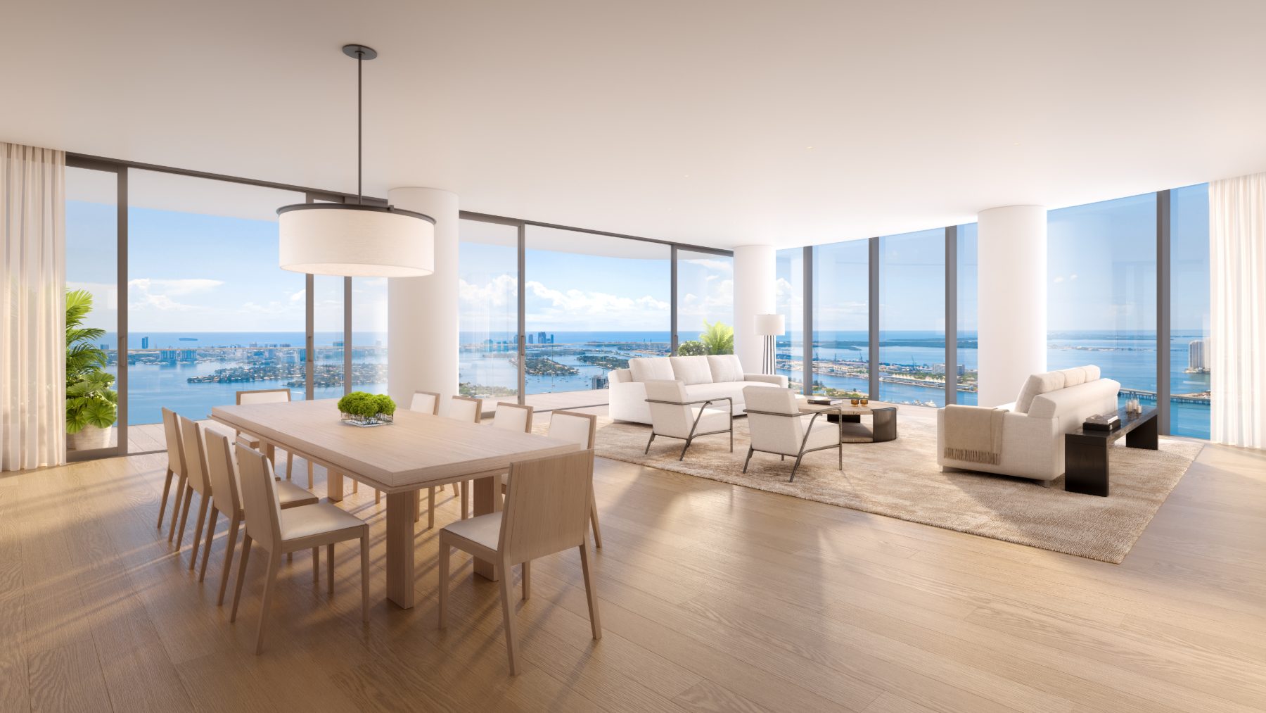 Rendering of an open-plan living and dining room with panoramic bay views at EDITION Residences Miami Edgewater